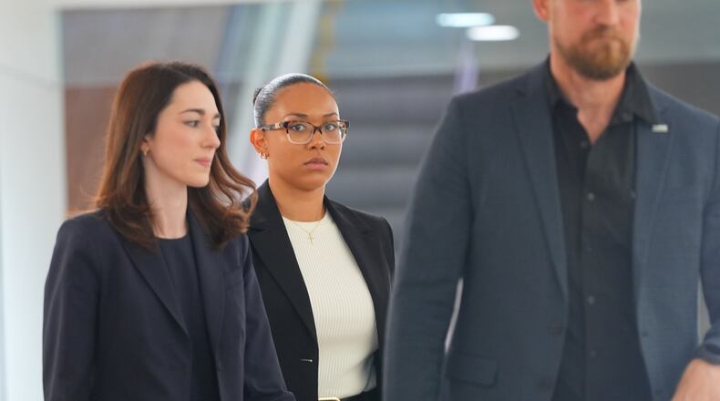 McKenna West, center, walks in a hallway before a court hearing in Dallas, Tuesday, Aug. 25, 2026. (AP Photo/LM Otero)