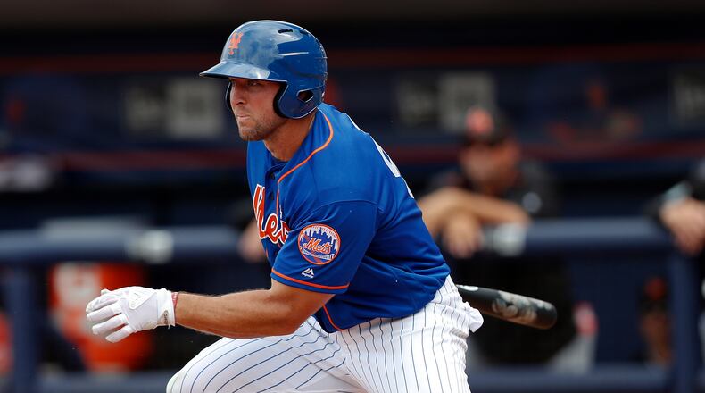 New York Mets' Tim Tebow make contact during a spring training baseball game against the Miami Marlins Monday, March 13, 2017, in Port St. Lucie, Fla.