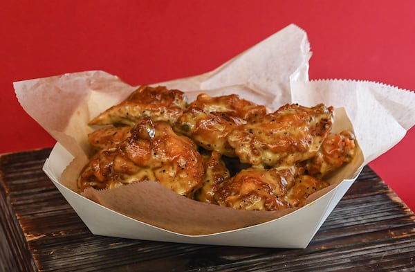 Lemon pepper wet wings are among the food offerings available from Proof of the Pudding during Atlanta Dream games at the Gateway Center Arena in College Park. Fans can find these at the Hangar concession stand. (Natrice Miller for the AJC)