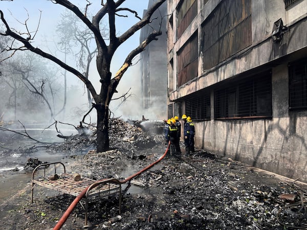 Firefighters work at the site of an airplane that crashed in India's northwestern city of Ahmedabad in Gujarat state, Thursday, June12, 2025. (AP Photo/Ajit Solanki)