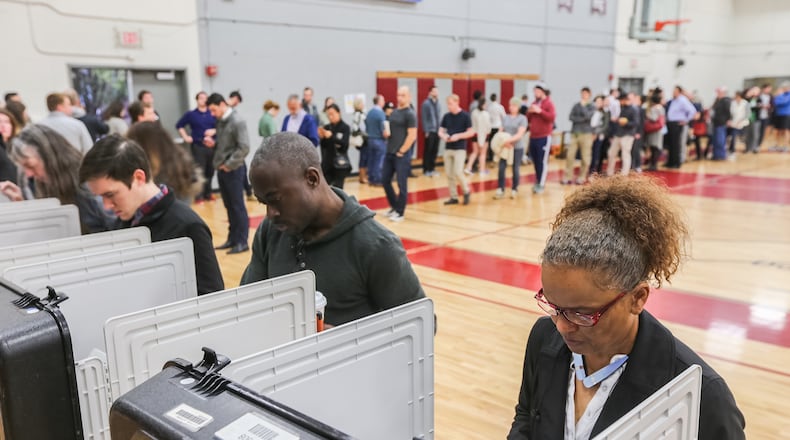 Election Day has doubled as a voting and working day for many, but that could change for city of Atlanta employees if the council votes on a law making it a holiday. JOHN SPINK / JSPINK@AJC.COM