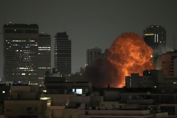 An explosion is seen during a missile attack in Tel Aviv, Israel, Sunday, June 15, 2025. (AP Photo/Leo Correa)