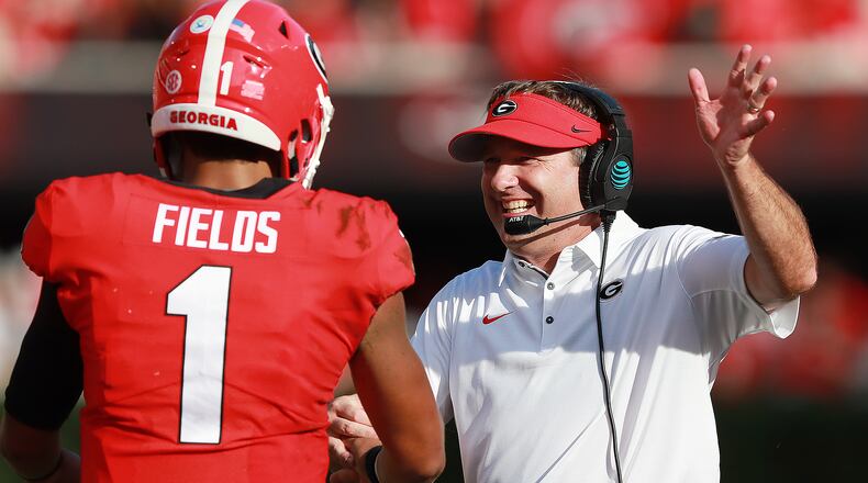 In happy times, Georgia head coach Kirby Smart celebrates a touchdown against Tennessee with quarterback Justin Fields.