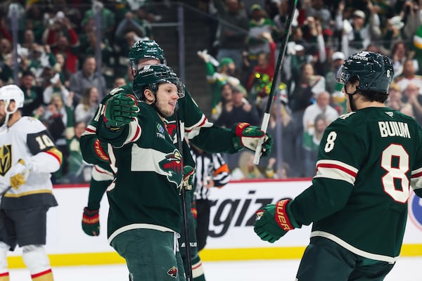 Minnesota Wild center Marco Rossi (23) is greeted by defenseman Zeev Buium (8) after scoring a goal against the Vegas Golden Knights during the first period in Game 4 of an NHL hockey Stanley Cup first-round playoff series, Saturday, April 26, 2025, in St. Paul, Minn. (AP Photo/Stacy Bengs)