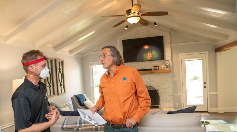 Ben Reeves, left, and Energy Consulting Services’ Shane Matteson, who performed the energy audit on this Roswell home, work together to prioritize energy loss improvements Wednesday, April 19, 2023. New federal tax credits for home energy improvements incentivize home owners to invest in an energy audit and update air leaks, add insulation and improve home efficiency to get federal tax credits, rebates and other financial benefits including with Georgia Power. (Jenni Girtman for The Atlanta Journal-Constitution)