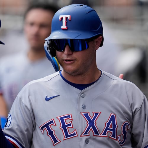 Texas Rangers designated hitter Joc Pederson (3) celebrates scoring off the bat of Brandon Nimmo in the third inning of a baseball game against the Atlanta Braves, Saturday, July 18, 2026, in Atlanta. (AP Photo/Mike Stewart)