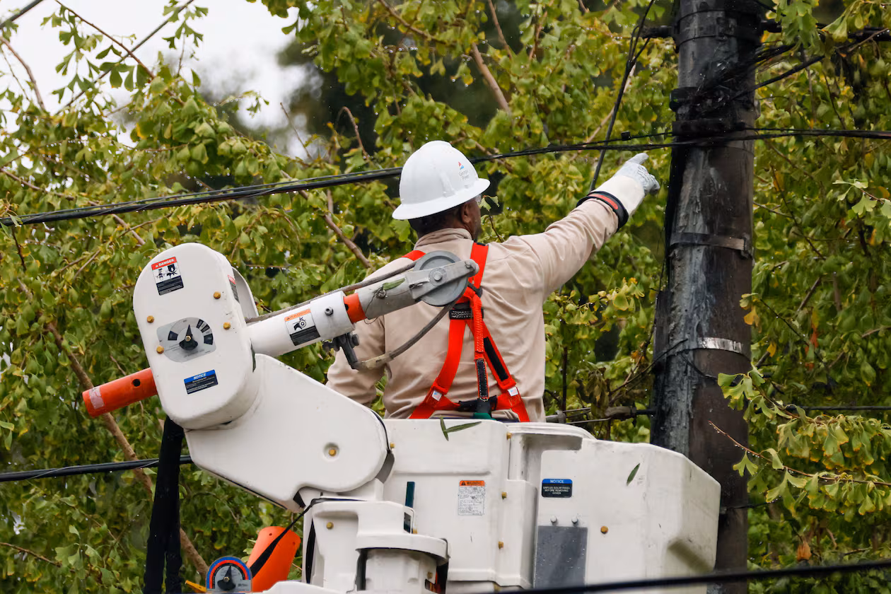 A worker works on power lines at Hill Street in Grant Park. The average customer will save $4.04 monthly thanks to agreement between the PSC and Georgia Power. (Miguel Martinez/AJC)