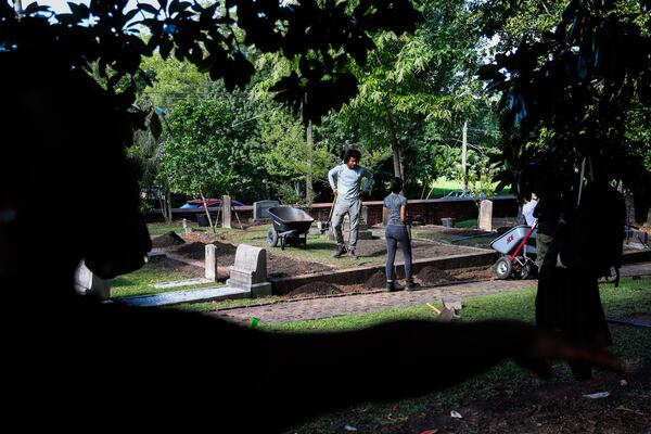 Hard at work in the Oakland Cemetery. (Abbey Cutrer/AJC)