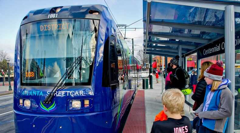 December 31, 2014 Atlanta - Shelby Jones (right) and her brother Dalton wait at the Centennial Olympic Park stop as an Atlanta Streetcar pulls up on Wednesday, December 31, 2014. Each streetcar can hold up to 200 riders. The new service takes about 30 minutes to make a round trip for each of the 12 stops. JONATHAN PHILLIPS / SPECIAL Shelby Jones (right) and her brother Dalton wait at the Centennial Olympic Park stop as an Atlanta Streetcar pulls up on Wednesday. Each streetcar can hold up to 200 riders. The new service takes about 30 minutes to make a round trip for each of the 12 stops. Jonathan Phillips/Special