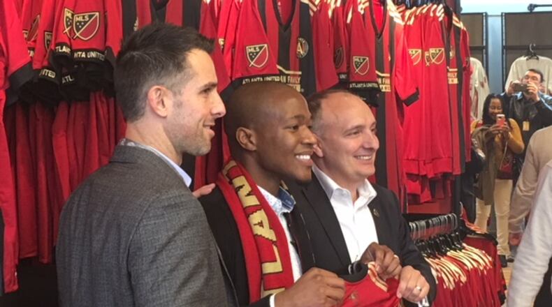 Atlanta United Vice President Carlos Bocanegra (left) and President Darren Eales (right) pose with Darlington Nagbe in December.