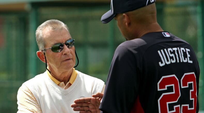 Braves president John Schulhotz, left, talks with former Brave David Justice in spring training in 2012, more than 15 years after Schuerholz traded to Justice to Cleveland. Jason Getz / AJC file