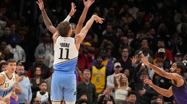 Atlanta Hawks guard Trae Young (11) scores, winning an NBA basketball game against the Los Angeles Lakers, Friday, Dec. 6, 2024, in Atlanta. (AP Photo/Brynn Anderson)