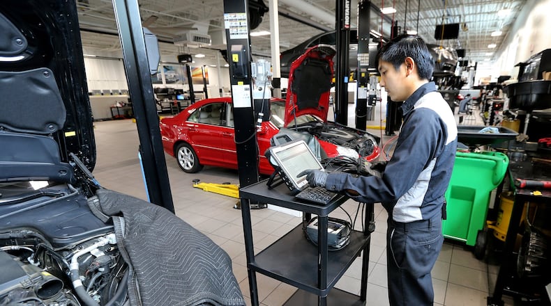 Technician Steven Liu, 26, works on a computer at Mercedes-Benz of Marietta. He was hired after completing a company training program designed to fill positions with skilled employees. (Curtis Compton/ccompton@ajc.com)