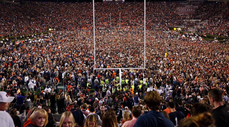 Fans rush the field after Auburn defeated Alabama in the Iron Bowl.