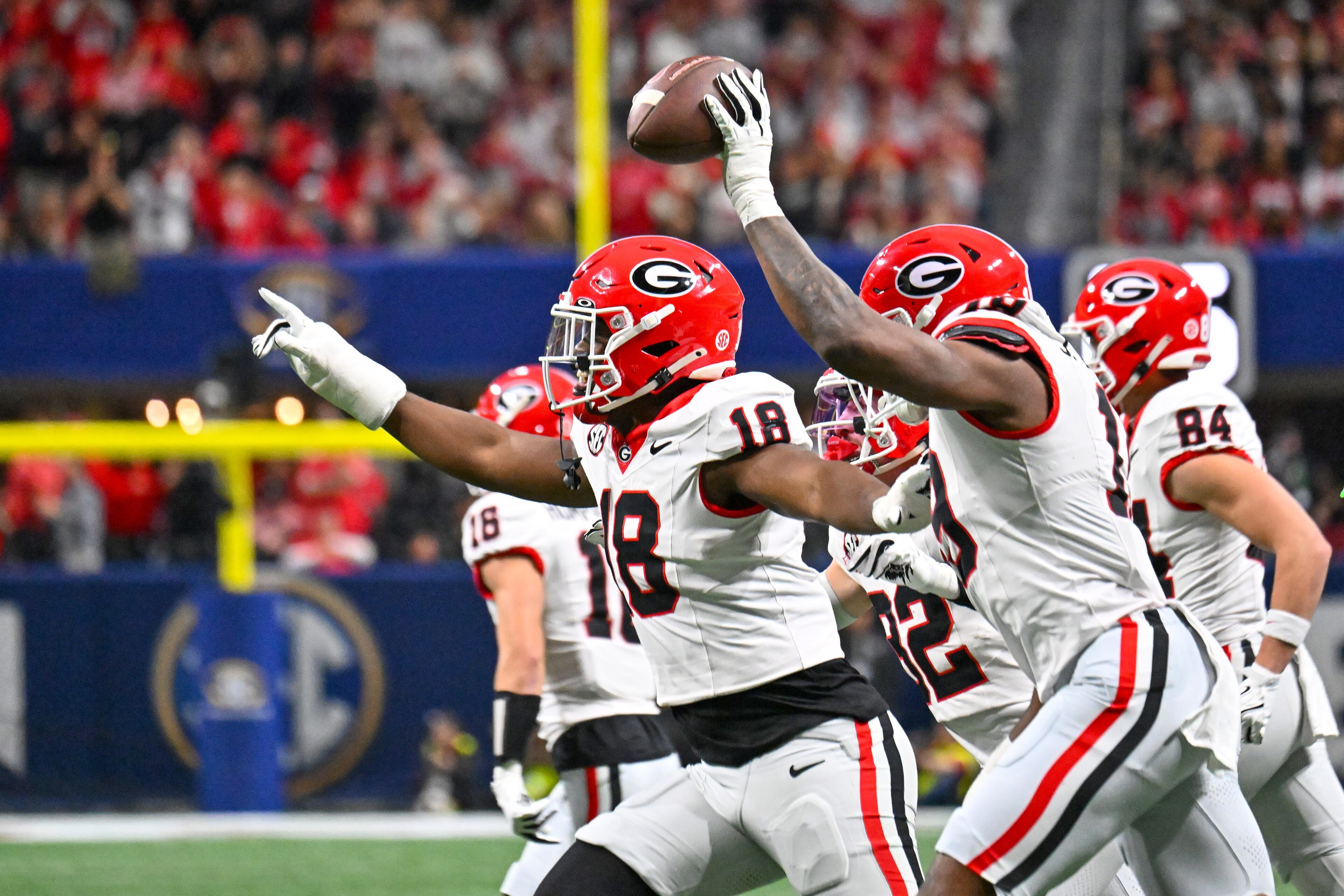 Georgia defensive team members brandish a blocked Alabama punt during the first quarter of the SEC Championship game at Mercedes-Benz Stadium, Saturday, Dec. 6, 2025, in Atlanta. (Hyosub Shin / AJC)