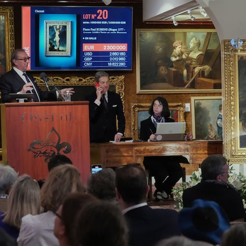 Auction officer Jean-Pierre Osenat gestures as the long-lost painting "Crucifixion of Jesus Christ" by Baroque master Peter Paul Rubens was sold at auction for 2,3 million euros or $2.66 million in Versailles, west of Paris, Nov. 30, 2025. (AP Photo/Michel Euler)