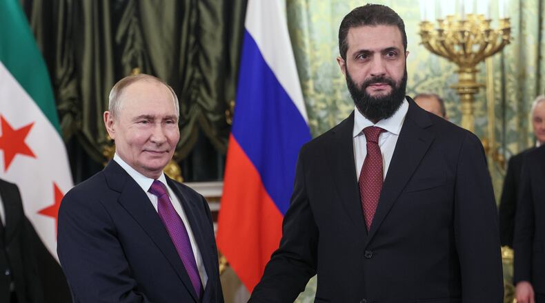 Russian President Vladimir Putin, left, and Syrian interim President Ahmad al-Sharaa pose for a photo during their meeting at the Grand Kremlin Palace in Moscow, on Wednesday, Jan. 28, 2026. (Maxim Shipenkov/Pool Photo via AP)