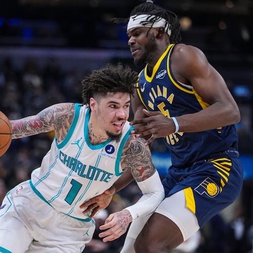 Charlotte Hornets guard Lamelo Ball (1) drives on Indiana Pacers forward Jarace Walker (5) during the first half of an NBA basketball game in Indianapolis, Wednesday, Nov. 19, 2025. (AP Photo/Michael Conroy)