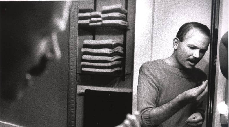 Tom Fox looking in the mirror at his home, shocked by the amount of hair he is losing, resulting from chemotherapy, Atlanta, Georgia, 1988-1989. Michael Schwarz / The Atlanta Journal-Constitution