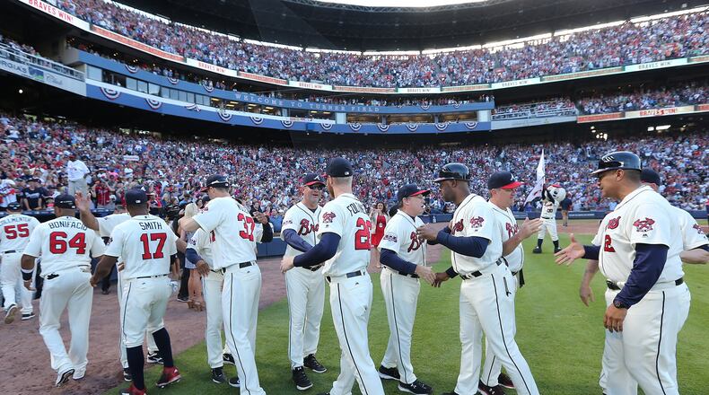 The Braves celebrate winning their final game at Turner Field. Curtis Compton /ccompton@ajc.com