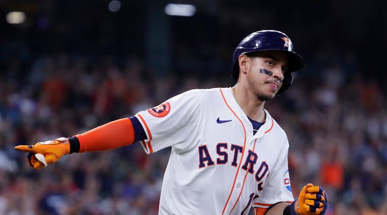 Houston Astros' Mauricio Dubon points to the dugout in celebration as he rounds the bases after hitting a home run against the Atlanta Braves during the sixth inning of a baseball game Wednesday, April 17, 2024, in Houston. (AP Photo/Michael Wyke)
