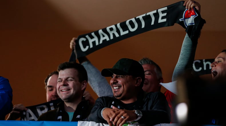 Soccer fans celebrate the announcement of a Major League Soccer team, owned by David Tepper, that will begin play Charlotte in 2021 at an event Tuesday, Dec. 17, 2019, in Charlotte, N.C.