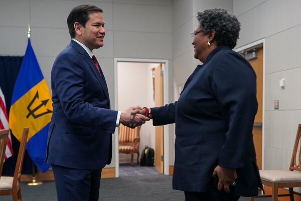 U.S. Secretary of State Marco Rubio, left, shakes hands with Barbados Prime Minister Mia Mottley at the U.S. Embassy in Kingston, Jamaica, Wednesday, March 26, 2025. (Nathan Howard/Pool Photo via AP)