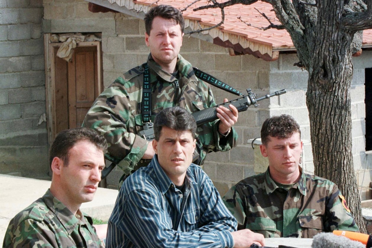 FILE - Hashim Thaci, head of the Kosovo Albanian negotiation team and head of the Kosovo Liberation Army political directorate, center, addresses a press conference in a secret location in central Kosovo, Saturday, March 13, 1999. (AP Photo/Visar Kryeziu, File)