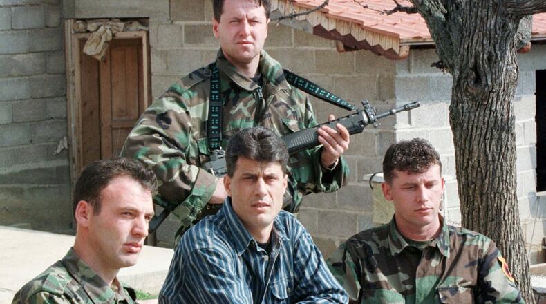 FILE - Hashim Thaci, head of the Kosovo Albanian negotiation team and head of the Kosovo Liberation Army political directorate, center, addresses a press conference in a secret location in central Kosovo, Saturday, March 13, 1999. (AP Photo/Visar Kryeziu, File)