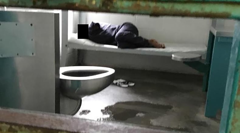 A woman lies on a thin mattress in her cell with water pooled at the foot of her metal bed, as seen during a midday visit at the South Fulton Municipal Regional Jail. This image is included in a federal lawsuit filed in April by the Georgia Advocacy Office and two women being held at the jail. The lawsuit includes graphic photos from a recent visit to the jail — among them this one — and details unimaginable conditions for the women detainees.