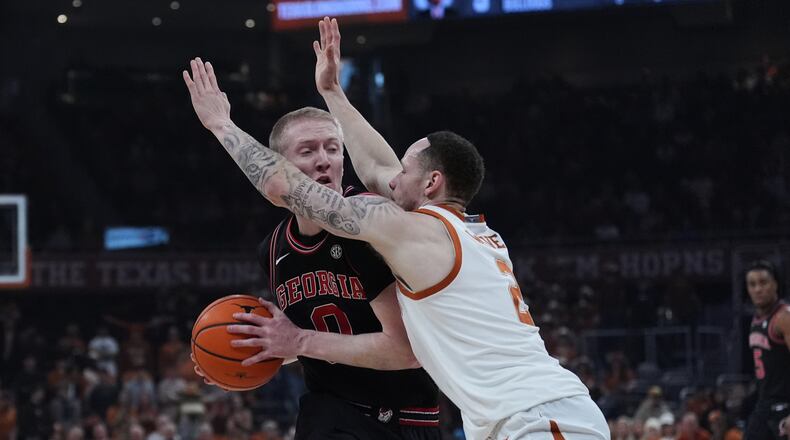Georgia guard Blue Cain is pressured by Texas guard Chendall Weaver during the first half of an NCAA college basketball game in Austin, Texas, Saturday, Jan. 24, 2026. (Eric Gay/AP)