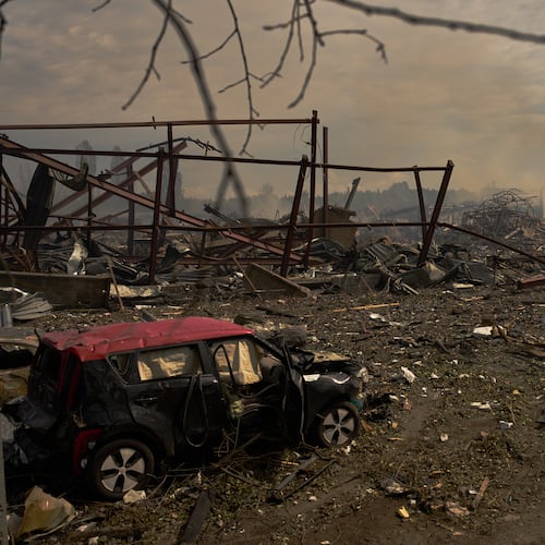 Destroyed vehicles and debris are scattered the day after a Russian attack struck a warehouse, followed by an explosion, in the village of Myla, outskirts of Kyiv, Sunday, Aug. 30, 2026. (AP Photo/Francisco Seco)