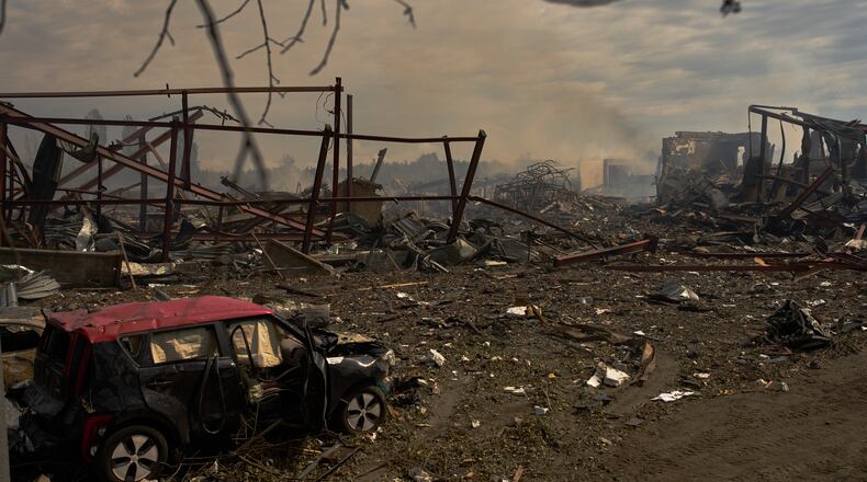 Destroyed vehicles and debris are scattered the day after a Russian attack struck a warehouse, followed by an explosion, in the village of Myla, outskirts of Kyiv, Sunday, Aug. 30, 2026. (AP Photo/Francisco Seco)