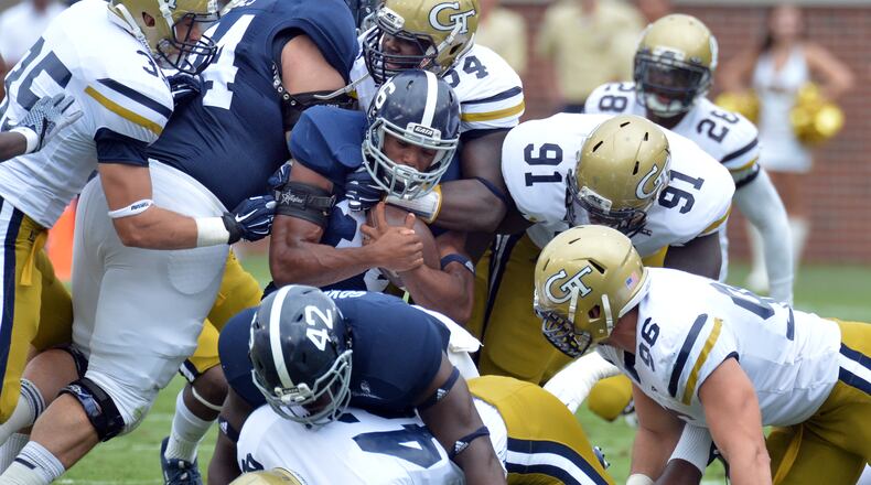 Georgia Tech’s defense gangs up on Georgia Southern’s Matt Breida in the first half Saturday. (Hyosub Shin/hshin@ajc.com)