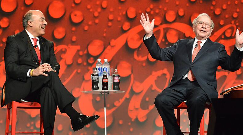 Coca-Cola CEO Muhtar Kent and billionaire Warren Buffett, the company’s largest shareholder, chat at the Atlanta beverage giant’s annual meeting Wednesday. Buffett brought along his ukulele (right), which he strummed during a video in which he sang a few lines of “I’d Like to Teach the World To Sing” from Coke’s iconic “Hilltop” commercial.