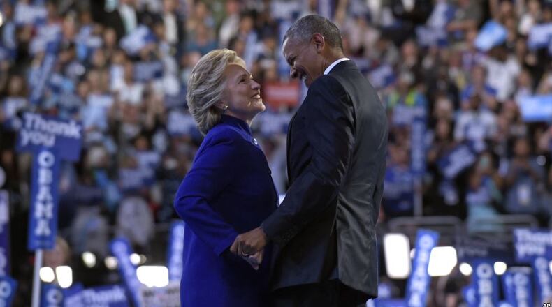 President Barack Obama, right, talks with Democratic presidential candidate Hillary Clinton, left, following Obama's speech at the Democratic National Convention in Philadelphia on Wednesday. (AP/Susan Walsh)