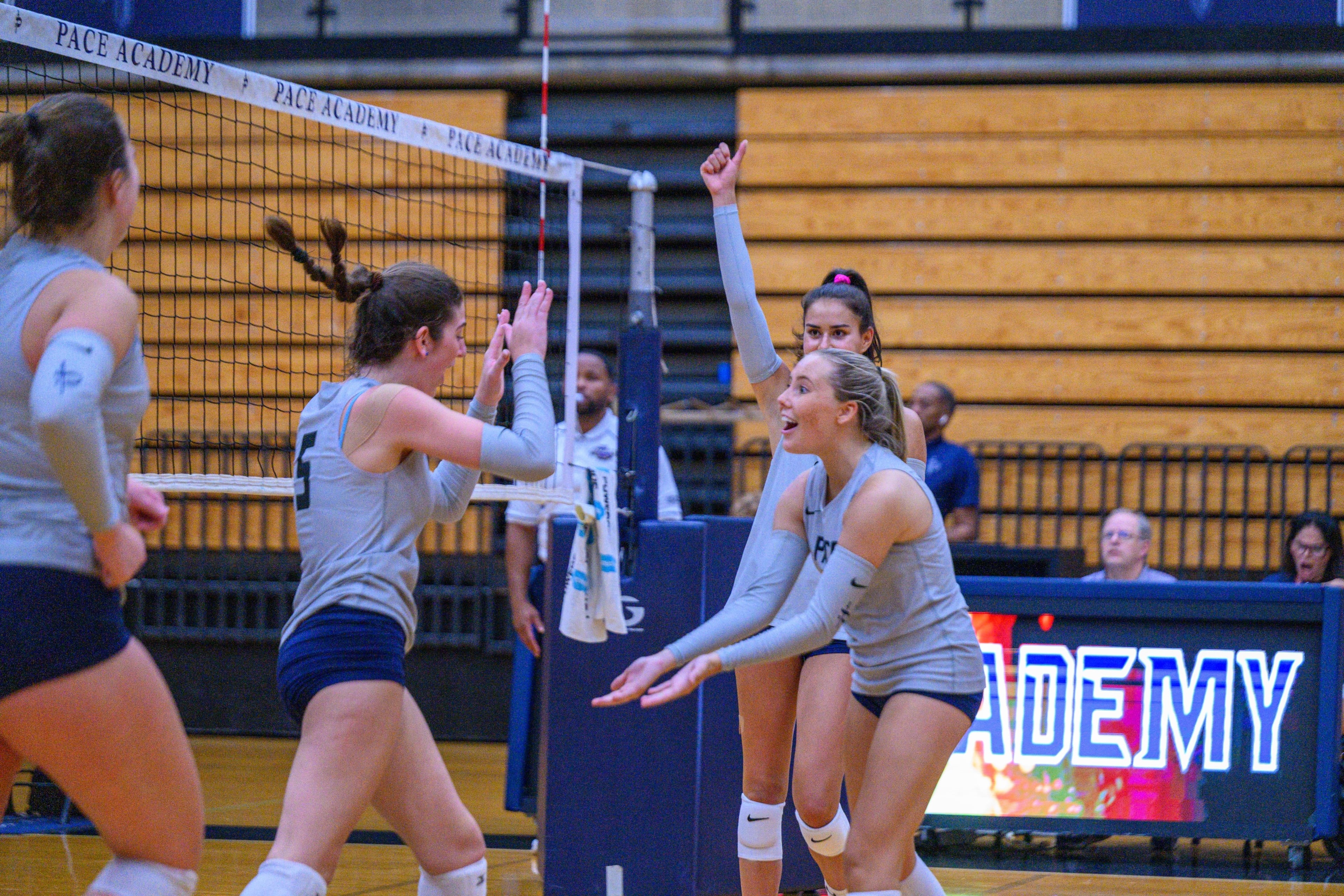 Pace Academy's Jolie Litvak (left) and Britton McGurn celebrate a winning point in August. (Courtesy of Pace Academy)