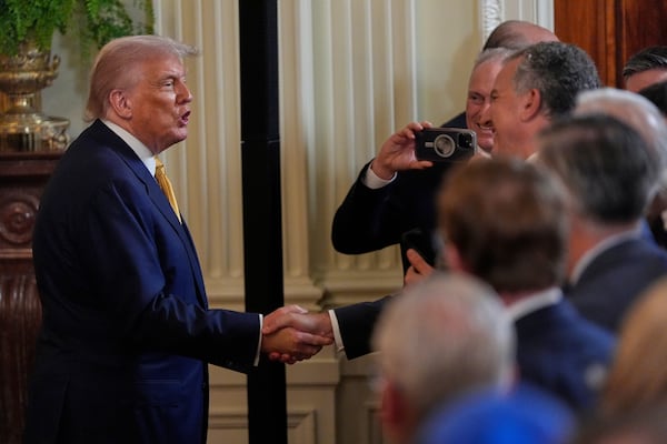 President Donald Trump greeted attendees at a reception for Republican members of Congress at the White House on Tuesday.