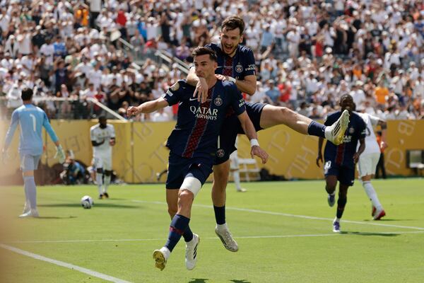 Paris Saint-Germain's Fabian Ruiz celebrates with team mate Khvicha Kvaratskhelia after scoring his side's opening goal during the Club World Cup semifinal soccer match between PSG and Real Madrid in East Rutherford, N.J., Wednesday, July 9, 2025. (AP Photo/Adam Hunger)
