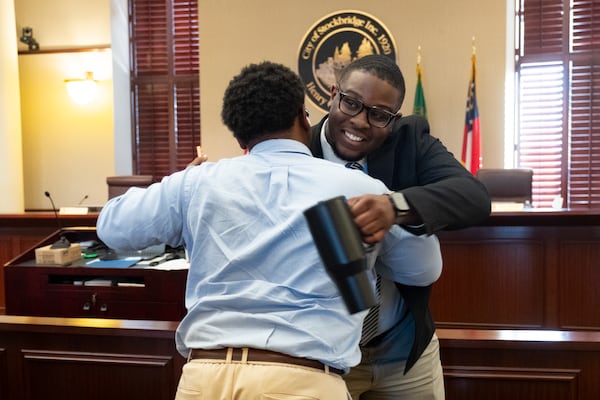 Stockbridge Mayor Jayden Williams hugs a supporter during a break in a City Council work session in Stockbridge on Tuesday, July 28, 2026. (Ben Gray for the AJC)