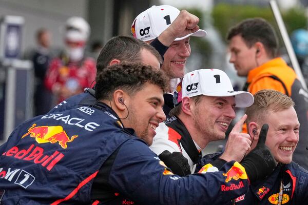 Red Bull driver Max Verstappen, center, of the Netherlands celebrates after winning the Japanese Formula One Grand Prix at the Suzuka Circuit in Suzuka, central Japan, Sunday, April 6, 2025. (AP Photo/Shuji Kajiyama, Pool)