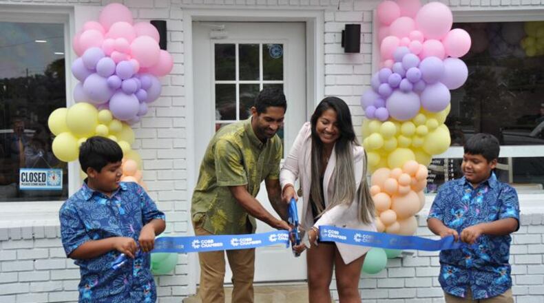 Owners Ikaika and Pierina Anderson cut the ribbon for the grand opening of their shop while twins Kekoa and Keoni Anderson hold the ribbon. (Courtesy of Olivia Wakim)