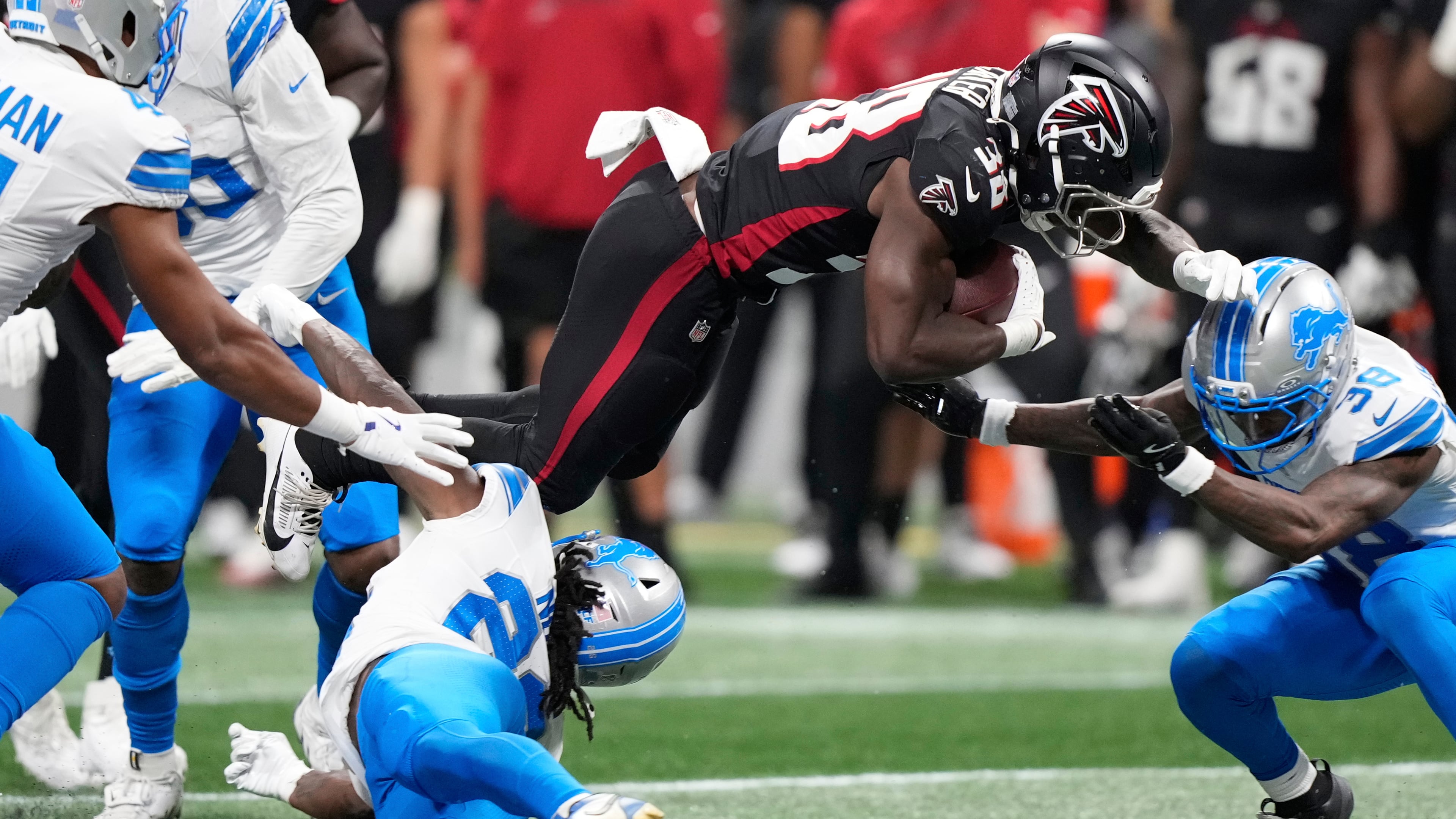 Lions safety Morice Norris is hit in the helmet by Falcons running back Nathan Carter during the second half of an NFL preseason football game on Friday, Aug. 8, 2025, in Atlanta. (Brynn Anderson/AP)