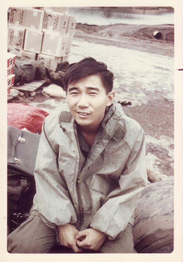 In this photo provided by William Fong, Fong is seen in 1969 sitting on a helicopter pad in Landing Zone Baldy, a U.S. military base in Vietnam. (William Fong via AP)