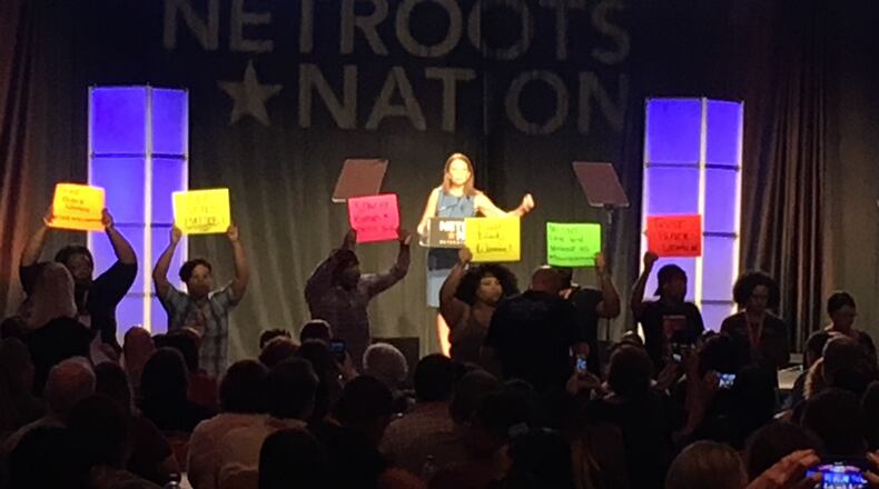 Stacey Evans is interrupted by protesters at her Netroots Nation speech. AJC/Greg Bluestein