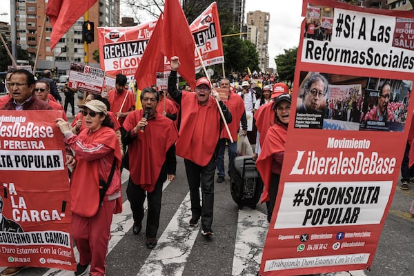 People participate in a march called by the central labor unions in support of Colombian President Gustavo Petro's intention to call by decree a popular consultation on labor reform in Bogota, Colombia, Wednesday, June 11, 2025. (AP Photo/Ivan Valencia)