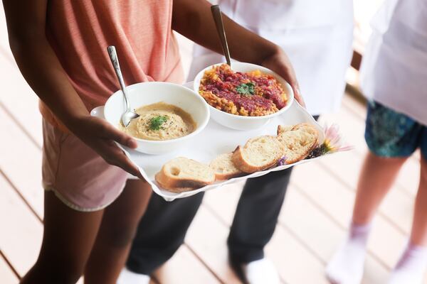 The Four Musketeers team present their dishes to a group of eight judges at the Wylde Culinary Arts Camp. (Abbey Cutrer/AJC)