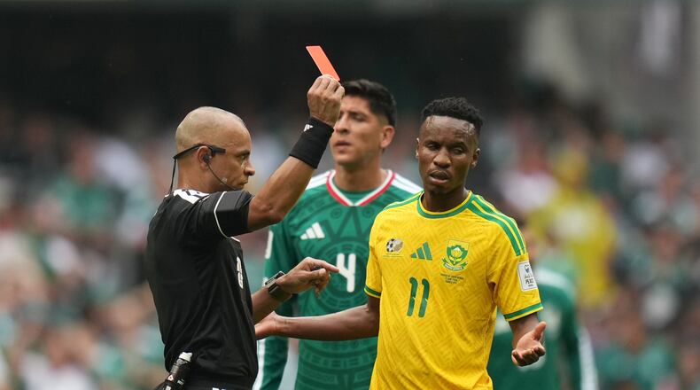Referee Wilton Sampaio, of Brazil, show the red card to South Africa's Themba Zwane during the World Cup Group A soccer match between Mexico and South Africa in Mexico City, Thursday, June 11, 2026. (AP Photo/Silvia Izquierdo)