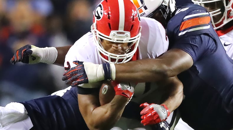 November 11, 2017 Auburn: Auburn defender Derrick Brown tackles Georgia running back Nick Chubb during the second half in a NCAA college football game at Jordan-Hare Stadium on Saturday, November 11, 2017, in Auburn.    Curtis Compton/ccompton@ajc.com