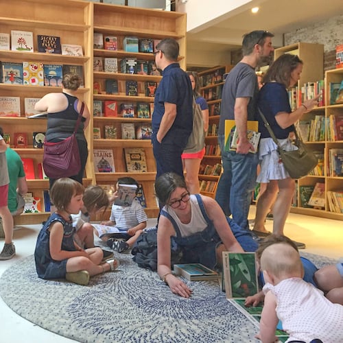FILE - Customers appear in the children's area of the Books Are Magic bookstore, owned by author Emma Straub, in Brooklyn, New York, on April 29, 2017. (AP Photo/Beth J. Harpaz, File)